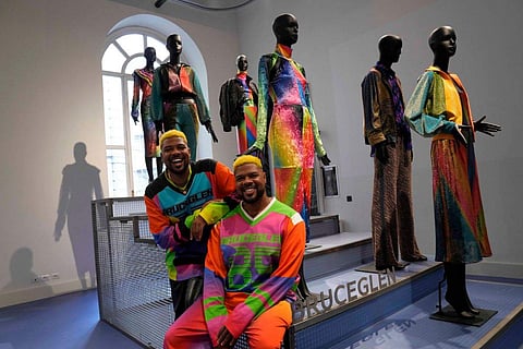 In frame:  Designers Glen and Bruce Proctor pose for portraits in front of their creations at the fashion hub