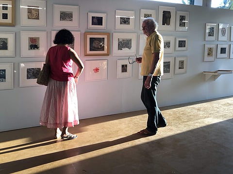 Visitors looking at art on display