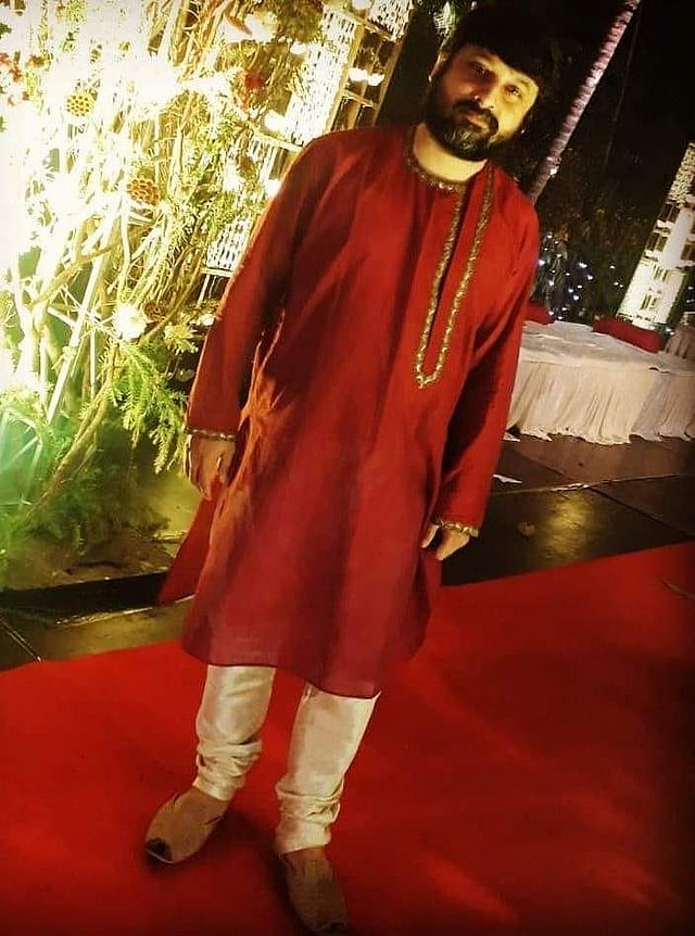 Director Shiboprosad Mukherjee in a <em>kurta</em> by <g class=