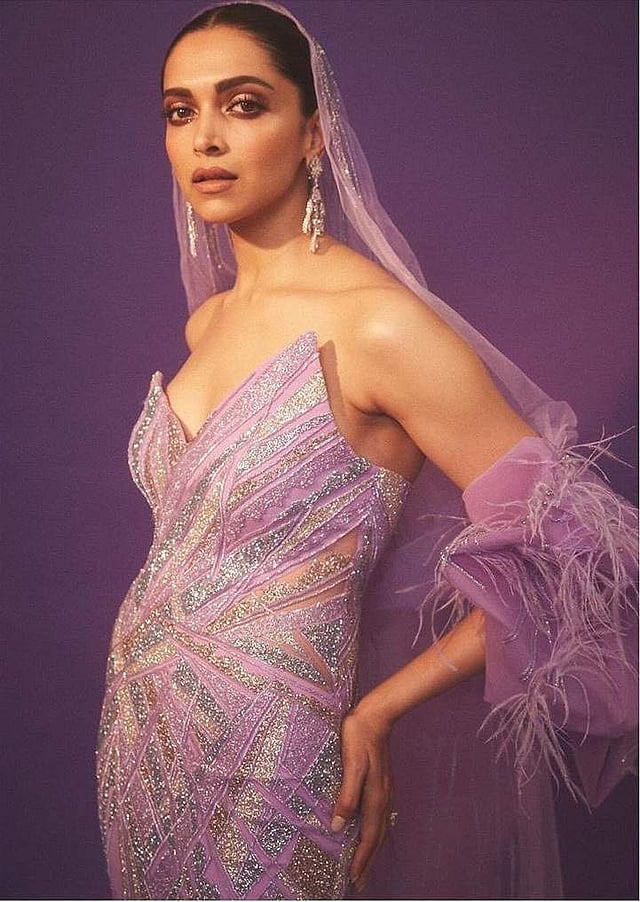 <em>Deepika recently rocked IIFA in a electric violet Gaurav Gupta gown with dramatic sleeves and a gossamer tulle hood, complimented with a soft feather trail</em>