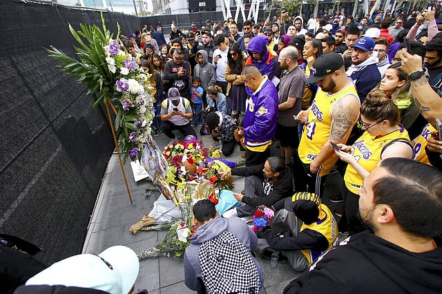 <em>Fans of Kobe Bryant mourn at a memorial in front of Staples Center, in downtown Los Angeles. (AP Photo/Matt Hartman)</em>