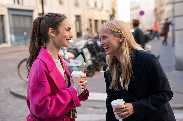 Lily Collins and Camille Razat, in Emily In Paris. Image Courtesy: Netflix